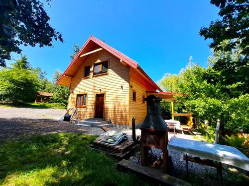 a small wooden house with a red roof at Chatô Liptov in Liptovský Mikuláš