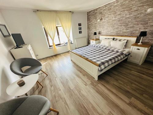 a bedroom with a bed and a brick wall at Casa de Vacanta Potoc - poarta ta spre Cheile Nerei in Potoc