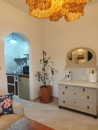 a living room with a dresser and a kitchen at Alexandria Aegean View in Gavrio