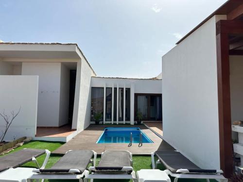 a swimming pool in the backyard of a house at Private villa with pool in the mountains in Pájara