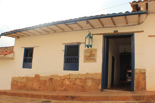 a building with an open door with a sign on it at Hotel Casa del Marquez de Bahichala in Barichara
