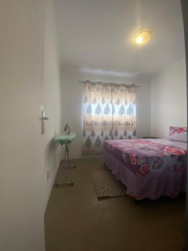 a bedroom with a bed and a cross on the wall at Fiet Star in Midrand