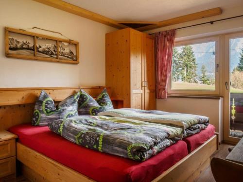 a bedroom with a bed and a window at Petererhof in Ellmau