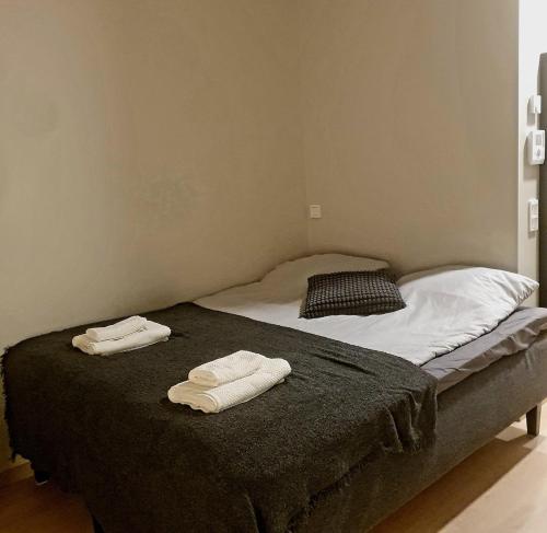 two towels on a bed in a room at Downtown studio, near railwaystation, with exercise facilities in Seinäjoki