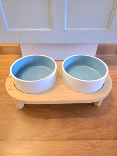two bowls are sitting on a wooden tray at Beach House in Surf Beach