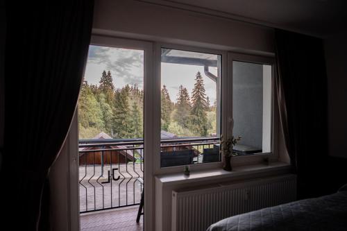 a bedroom window with a view of a balcony at ADELA VIP Nezábudka - Tiché krídlo, 45m2 a TOP spánok in Tatranska Strba