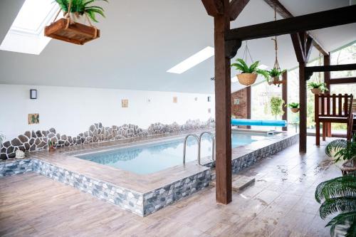 a swimming pool in a room with a table and chairs at ADELA VIP Nezábudka - Tiché krídlo, 45m2 a TOP spánok in Tatranska Strba