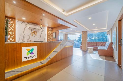 a lobby of a hotel with a therapeutic sign on the wall at Treebo Medco Mansion in Kozhikode