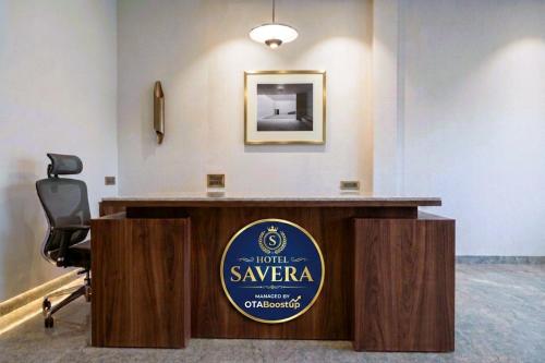 a sign for a hotel waveragency sits on top of a reception desk at Hotel Savera Amritsar Near Golden Temple in Amritsar