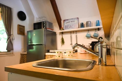 a kitchen with a sink and a green refrigerator at Jó, hogy itt vagy! in Orfű