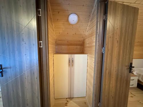 a refrigerator in a room with wooden walls at Iliaseuli's Cottage in K'vemo Jocho