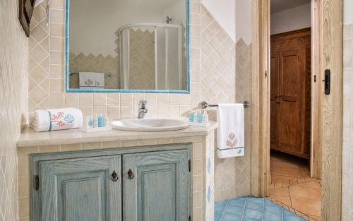 a bathroom with a sink and a mirror at Big Pevero Sea View House 7 Two Bedrooms in Porto Cervo
