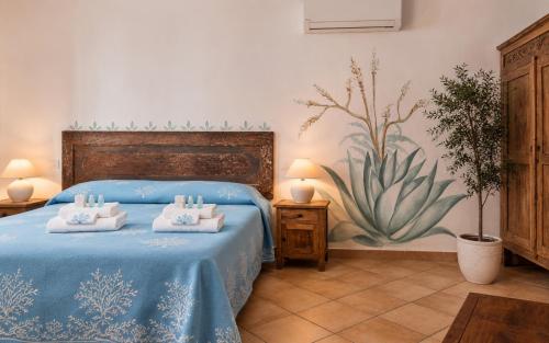 a bedroom with a blue bed with towels on it at Big Pevero Sea View House 7 Two Bedrooms in Porto Cervo