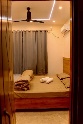 a bedroom with a bed with two towels on it at Aarunya Stays in Rishīkesh