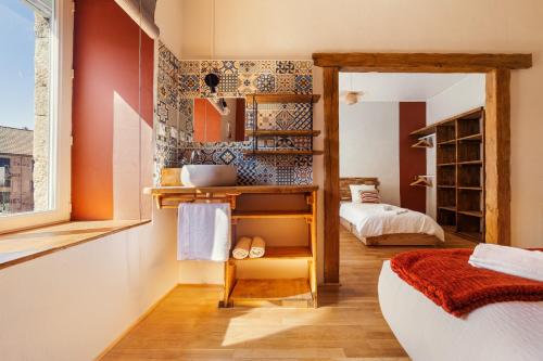 a room with a bedroom with a bed and a mirror at Ma Bégude in Rieutord
