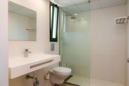 a bathroom with a toilet and a sink and a shower at MallorcaRooms Cala Millor in Cala Millor