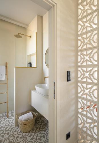 a bathroom with a toilet and a sink and a mirror at TERTH - Afytos Experience in Afitos