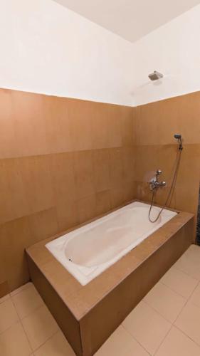 a large bath tub in a room with at Tamil Megam Villa in Chennai
