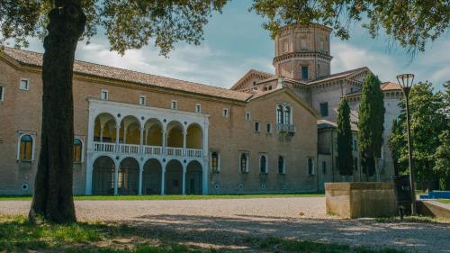 a large brick building with a tower on top at Domus Dantis - Italian Homing in Ravenna