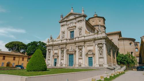 an old building with a tree in front of it at Domus Dantis - Italian Homing in Ravenna
