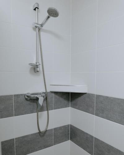 a shower with a shower head in a bathroom at ŠD Jedlíkova 9 in Košice