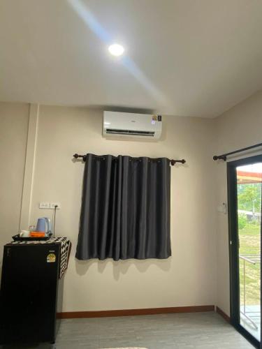 a room with a black curtain and a window at The sun homestay01 in Ko Kood