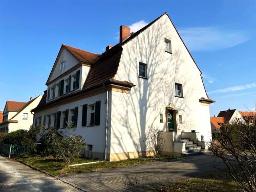 a large white building with a brown roof at Villa Seenswert in Lauta