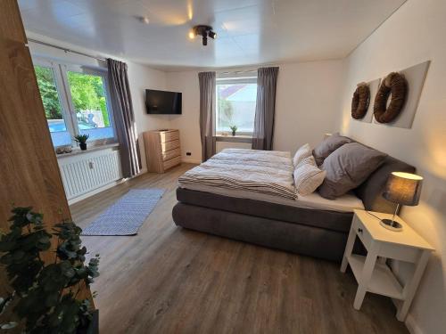 a bedroom with a bed and a television in it at Wohnen auf dem Lande in Wiemersdorf