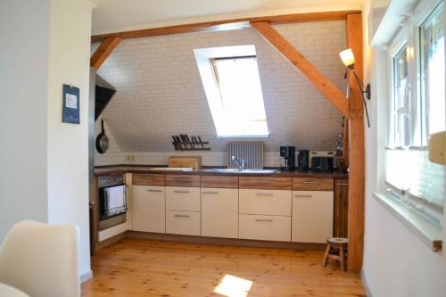 a kitchen with a sink and a window at Ferienwohnung "ZU HAUSE" in Guben