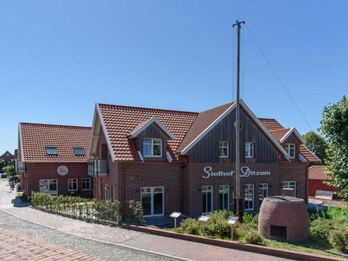 a red brick building with a black roof at Sielhof Ditzum 45263 in Ditzum