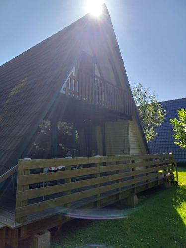 a house with the sun shining on the front of it at Nordseenest in Butjadingen