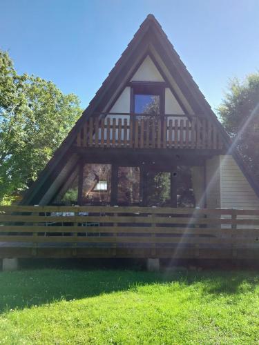 a house with a porch and a wooden fence at Nordseenest in Butjadingen