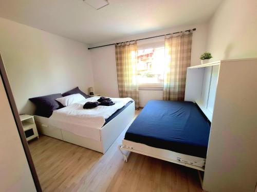 a small bedroom with two beds and a window at Apartment Weißer Burgunder in Bad Sachsa