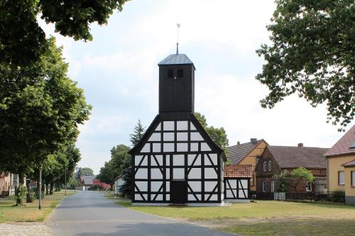 a black and white building with a clock tower at Spreewald-Pension Marina in Lübben