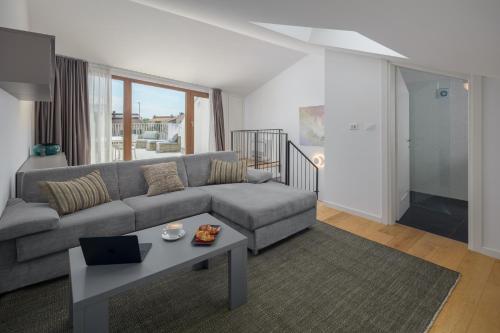 a living room with a couch and a table at Maj Premium Residence in Poreč