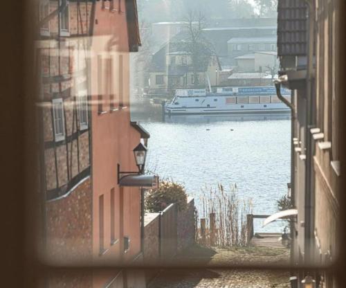 a view of a river from a window of a building at Inseldomizil - Melina in Malchow