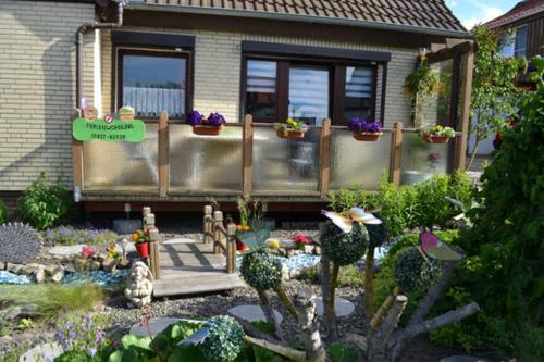 a garden in front of a house with plants and flowers at Ferienwohnung Anneli Edert in Bad Harzburg
