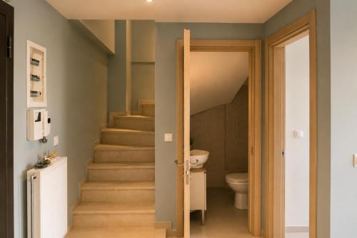 a bathroom with a staircase leading to a toilet at Alia Beachfront Penthouse with Sea View in Lefkandi Chalkidas