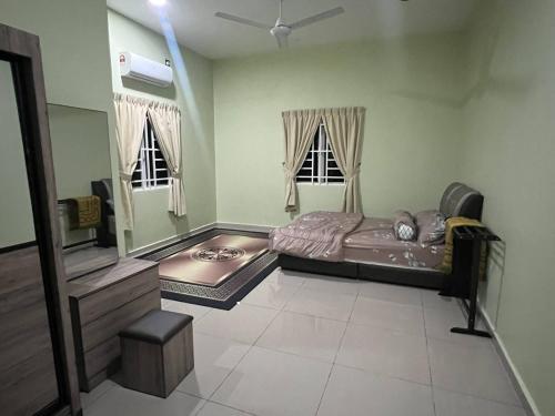 a bedroom with a bed and a mirror in it at Homestay Abah in Bidur