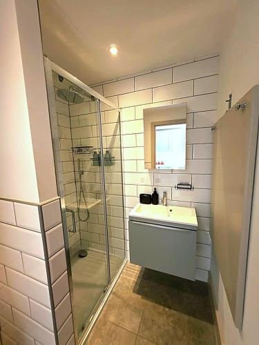 a bathroom with a sink and a glass shower at The Hayloft in Ringwood