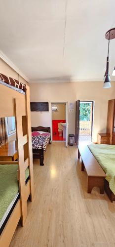 a room with two bunk beds and a bathroom at Budget Hostel in Mestia in Mestia