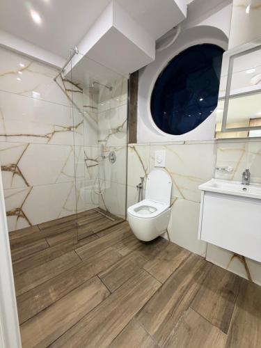 a bathroom with a toilet and a sink at EDEAN Apartments 4 in Tirana