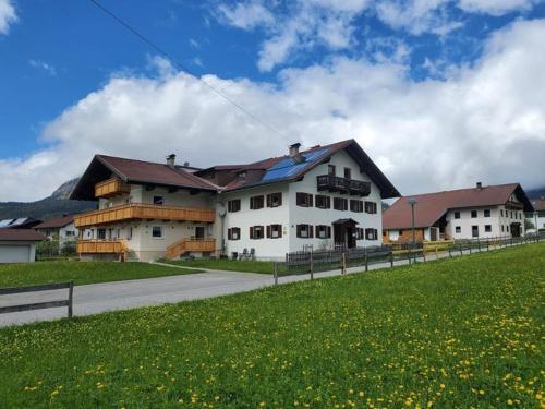 a large white building on the side of a road at Rosa s Ferienhaus in Grän