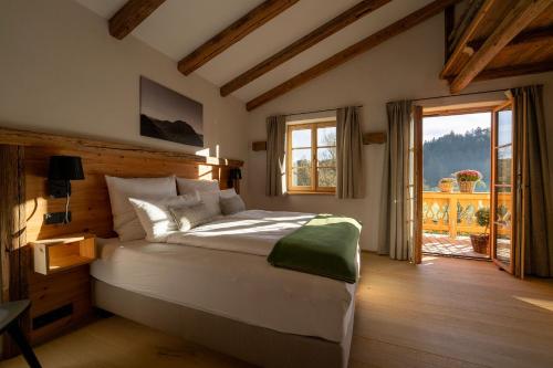 a bedroom with a large bed and a large window at Ferienwohnungen Fendl in Fischbachau