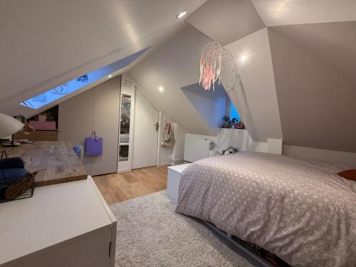 a white bedroom with a bed and a bathroom at Bienvenue au 24 in Le Havre