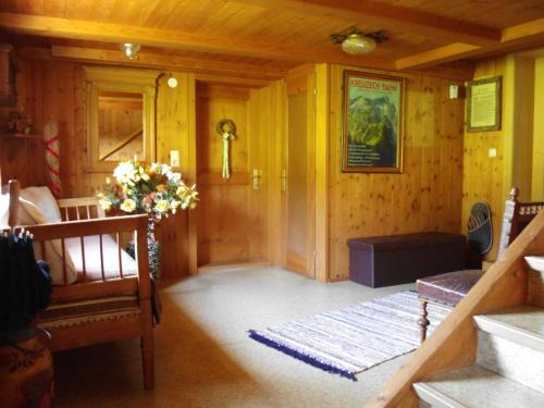 a living room with wood paneled walls and a hallway at Gästehaus Wiesenhof in Schwarzenberg