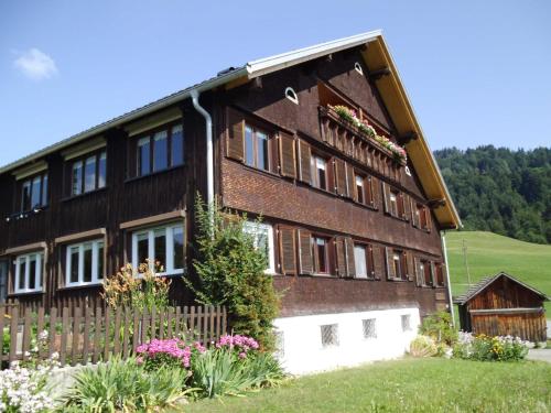 a large brick building with flowers in front of it at Gästehaus Wiesenhof in Schwarzenberg