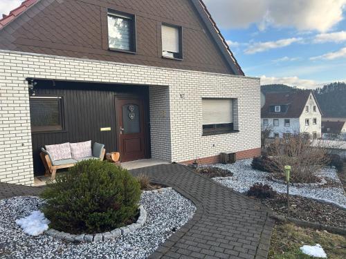 a house with a garage with a couch in it at Ferienhaus Windrödel in Herzhausen