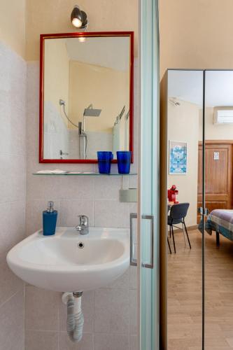 a bathroom with a sink and a mirror at Hotel Por Santa Maria in Florence