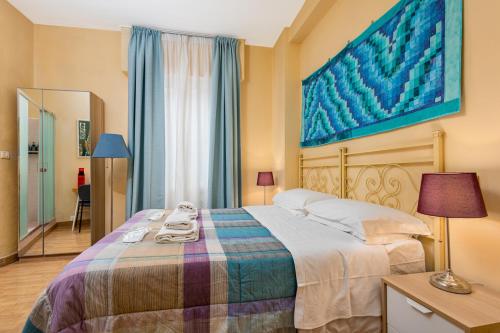a bedroom with a bed and a large painting on the wall at Hotel Por Santa Maria in Florence